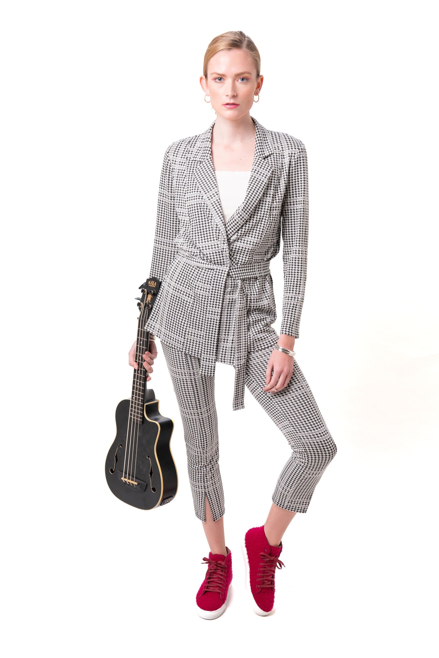 Woman in a checkered suit holding a guitar on a white background with Fuschia Le Mondeur Shoes